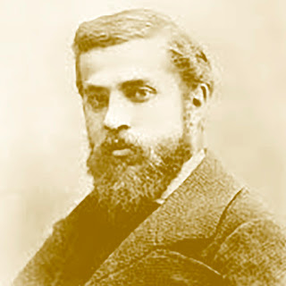 Antoni Gaudí: Retrato antigo em tom sépia de um homem jovem com barba densa e cabelos curtos, vestido com um paletó de lã.