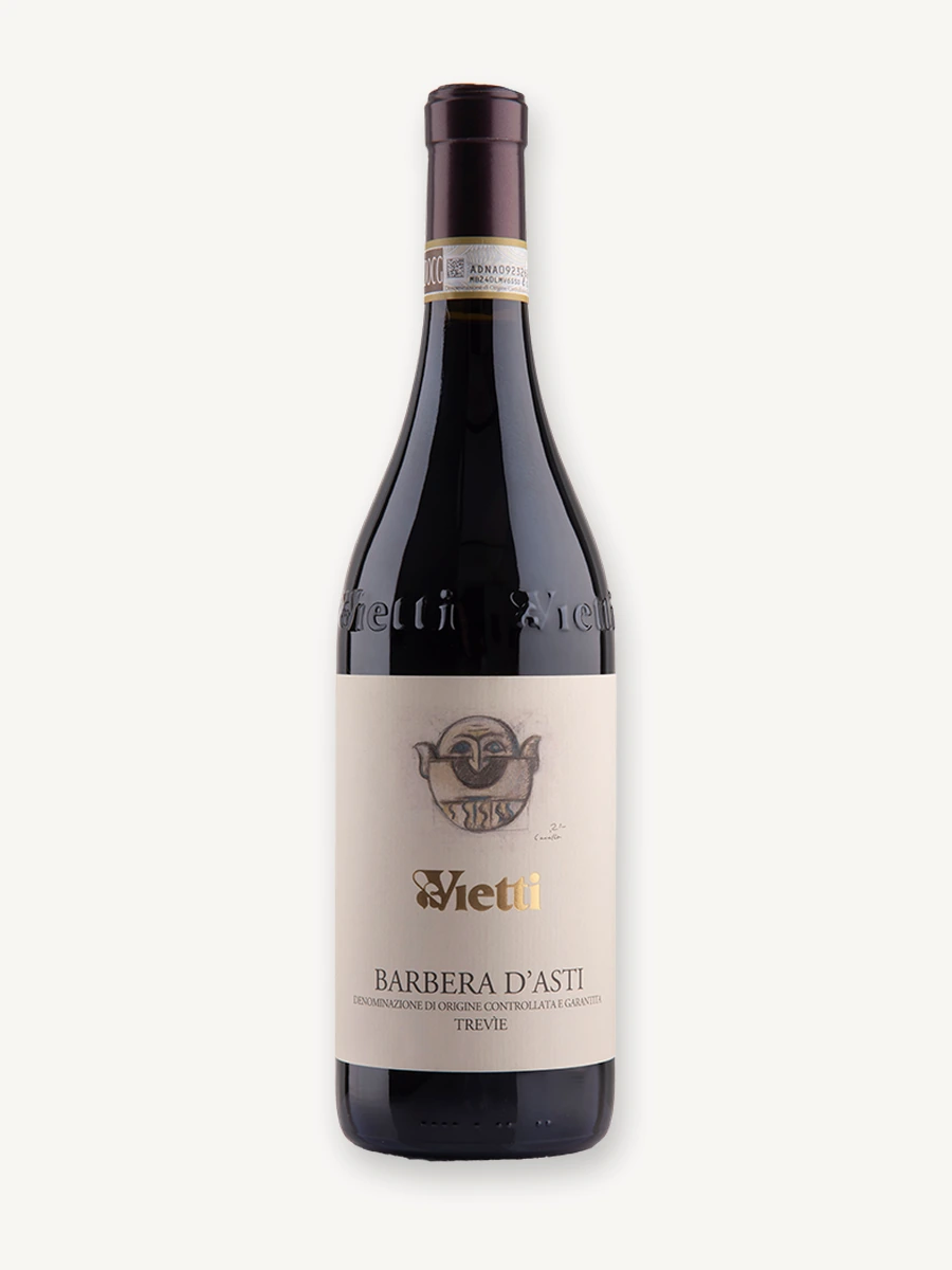 Uma garrafa de vinho tinto da marca Vietti, especificamente um Barbera d'Asti Tre Vigne, com fundo branco isolado.