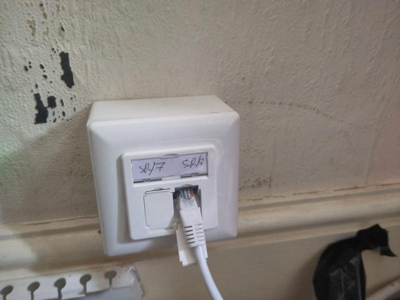 Photo of an ethernet faceplate, theres a cable in one port