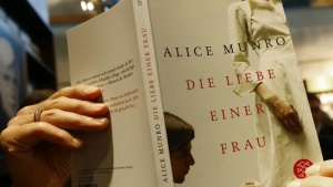 An employee of publisher S.Fischer holds up book by Nobel Prize in Literature winner  Munro  during book fair in Frankfurt